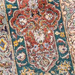 Persian Tabriz type carpet, the teal ground decorated with central medallion, radiating palmettes and dense floral scrollwork, within multiple floral borders