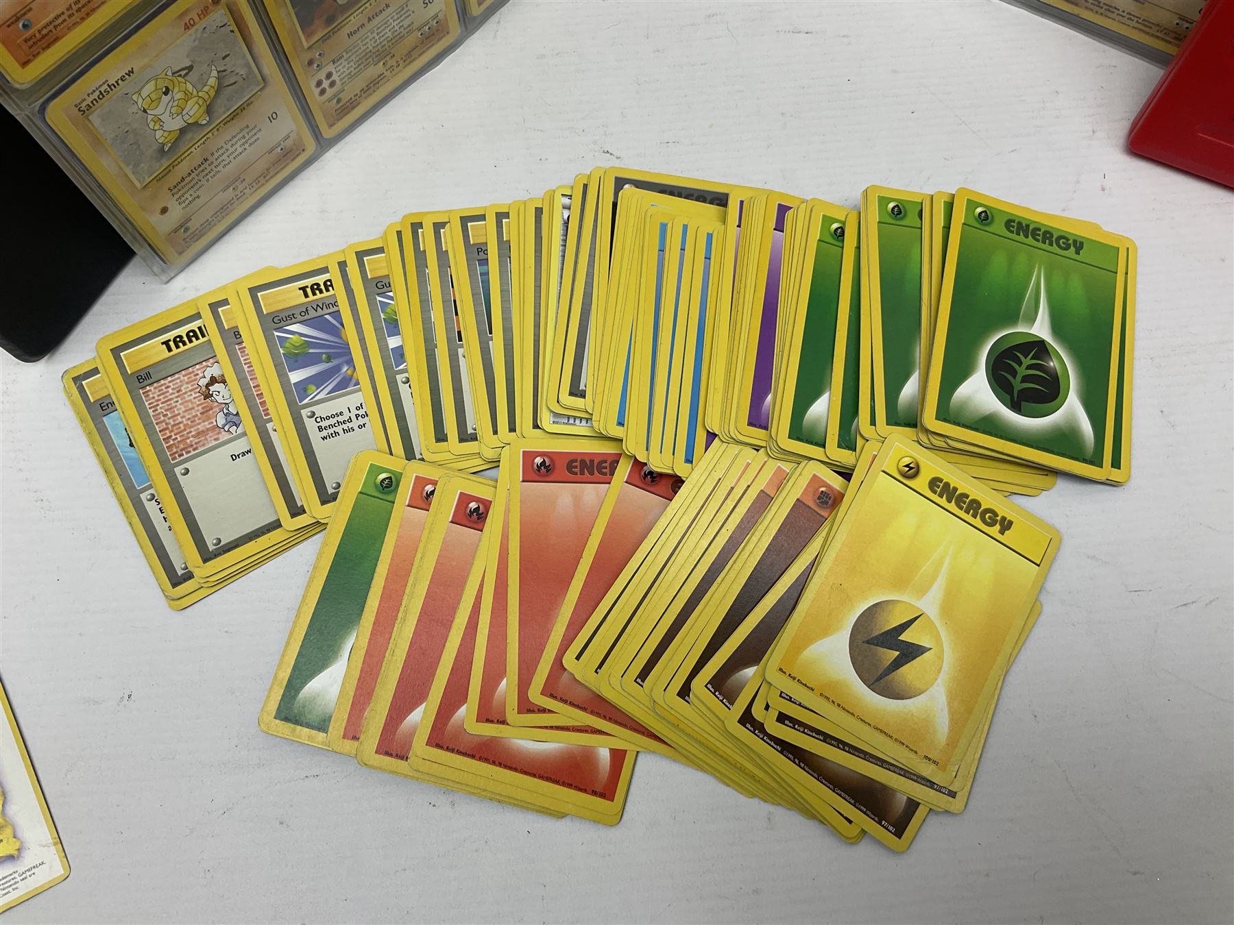 Collection of Pokemon trading cards, mostly 1999 Wizards Pokemon cards to include holo Charizard 4/102, first edition holo Machamp 8/102, further holographic cards; Dark Flareon 35/82 and Dark Vaporeon 45/82, cards from themed sets and 4th edition prints; 1998 Electronic Pokédex with cardboard boxes for themed decks Blackout, Overgrowth and Power Reserve Jungle, along with a large quantity of energy and trainer cards 
