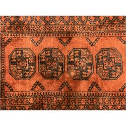 Near pair Afghan Bokhara wool pile rugs, the field decorated with four central Gul motifs, surrounded by multi-band border with repeating lozenges (2)