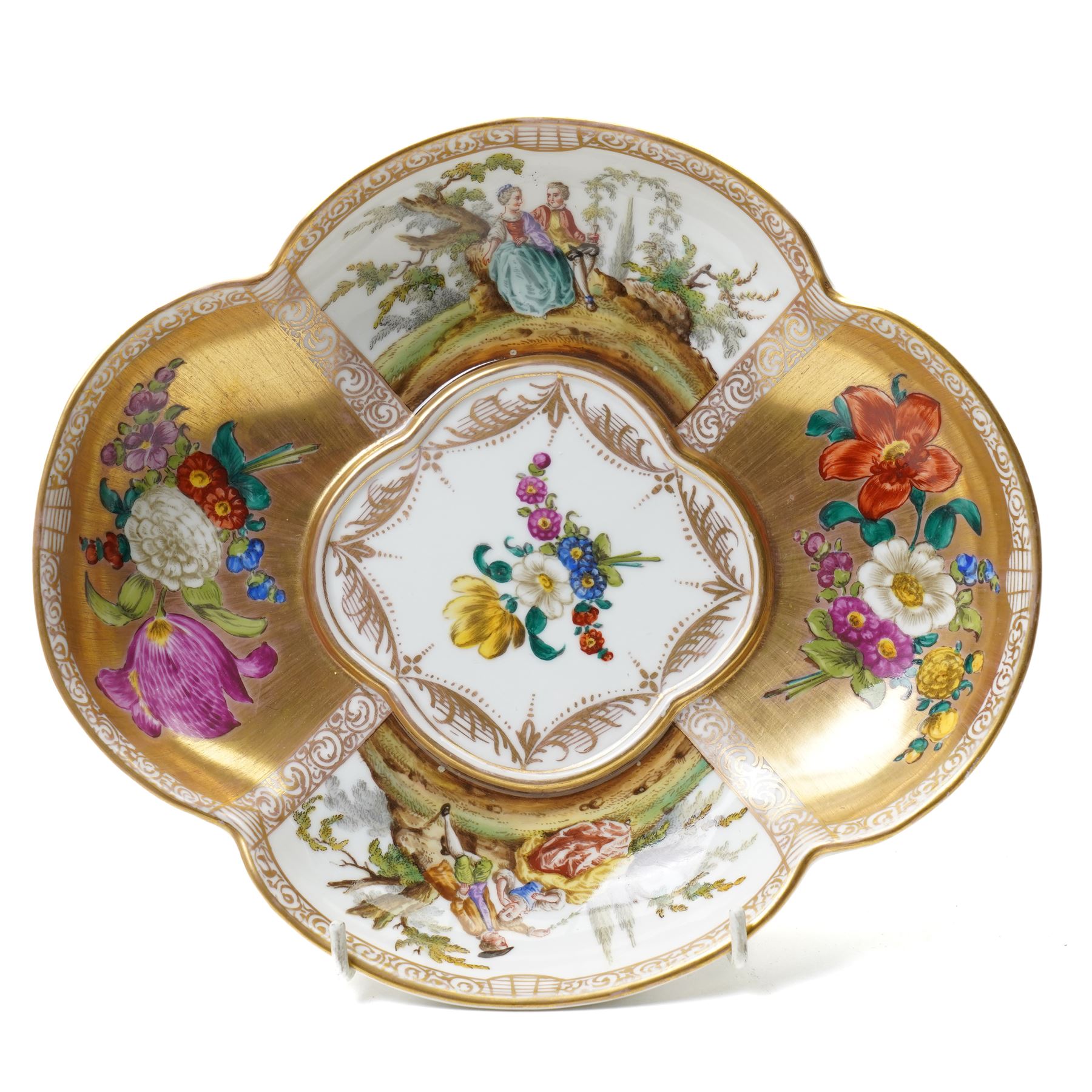 Collection of Helena Wolfsohn Dresden porcelain works, comprising a quatrefoil dish, D24cm, a chocolate cup with socketed saucer, two teacups, one with saucer, and a pair of twin-handled covered cups, each decorated with panels of flowers and courting scenes, various blue marks to bases