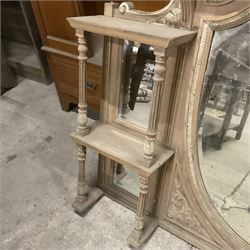 Late 19th century pine and gesso mirror back or wall mirror, pierced broken swan neck pediment decorated with foliate and central flower head motif, shield shaped bevelled mirror, the spandrels decorated with scrolled foliate decoration, two tier shelves on turned and fluted supports  - THIS LOT IS TO BE COLLECTED BY APPOINTMENT FROM THE OLD BUFFER DEPOT, MELBOURNE PLACE, SOWERBY, THIRSK, YO7 1QY
