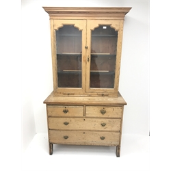 19th century pine cabinet on chest, projecting cornice, two doors enclosing three adjustable shelves, two slides above two short and two long drawers, shaped solid end supports, W108cm, H200cm, D54cm