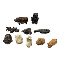 Group of ten Japanese netsukes, comprising eight carved wooden examples, and two ivorine examples, of various form, examples modelled as pigs, owl, mouse with tortoise upon its back, birds, rabbit, etc. 