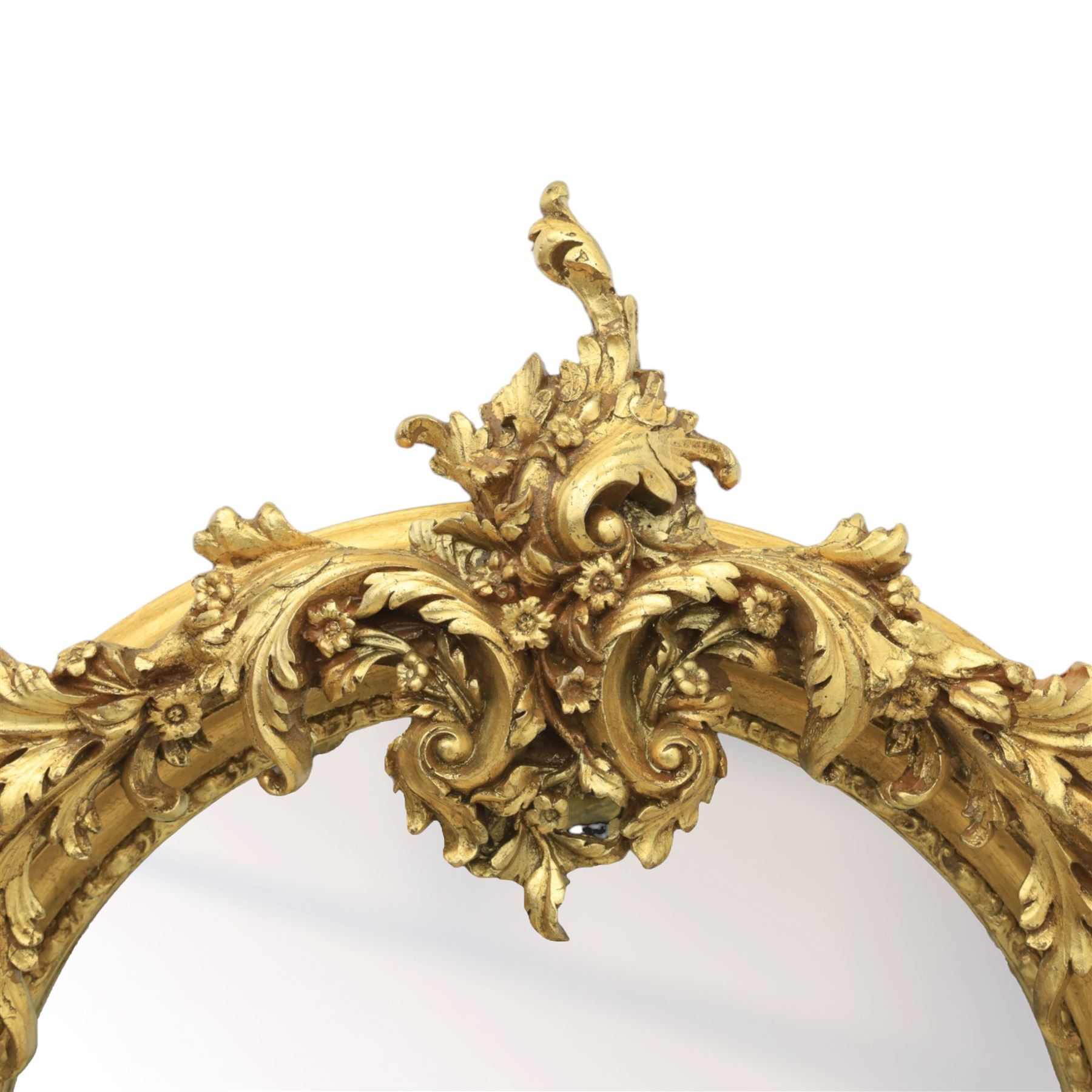 Pair of Louis XV style giltwood overmantel mirrors, the arched rectangular frame surmounted by an elaborate pierced cresting of acanthus scrolls, rocailles and floral swags, the moulded frame with continuous foliate carving and beaded inner slip