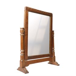Mouseman - 1930s/40s lightly adzed dark oak dressing table swing mirror, the arcade carved cresting rail over a rectangular plate, the mirror pivots between two lappet-carved turned octagonal supports with dished tops, raised on sledge feet, with carved mouse signature, by the workshop of Robert Thompson of Kilburn