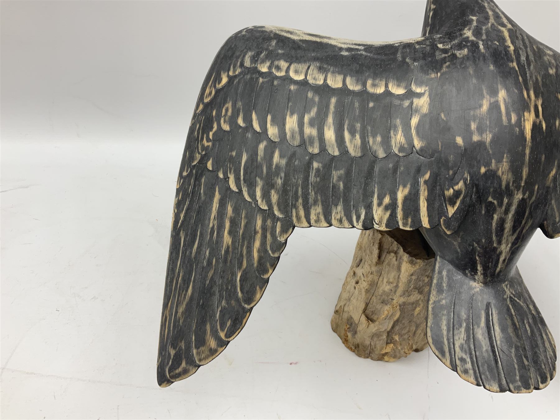 Wooden sculpture of Cormorant aquatic bird on a naturalistic wooden plinth, H46cm