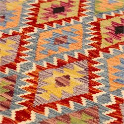 Afghan Chobi flatweave kilim, with a repeating stepped diamond medallion design in ivory, green, rust, teal, purple, indigo, and framed by chevron and geometric borders
