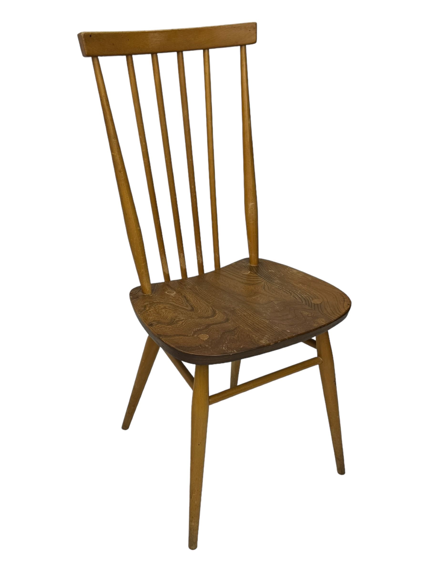 Ercol - pair of mid-20th century highback 'Windsor' chairs, curved top rail over six vertical spindles and shaped seat, on tapering cylindrical supports with stretchers
