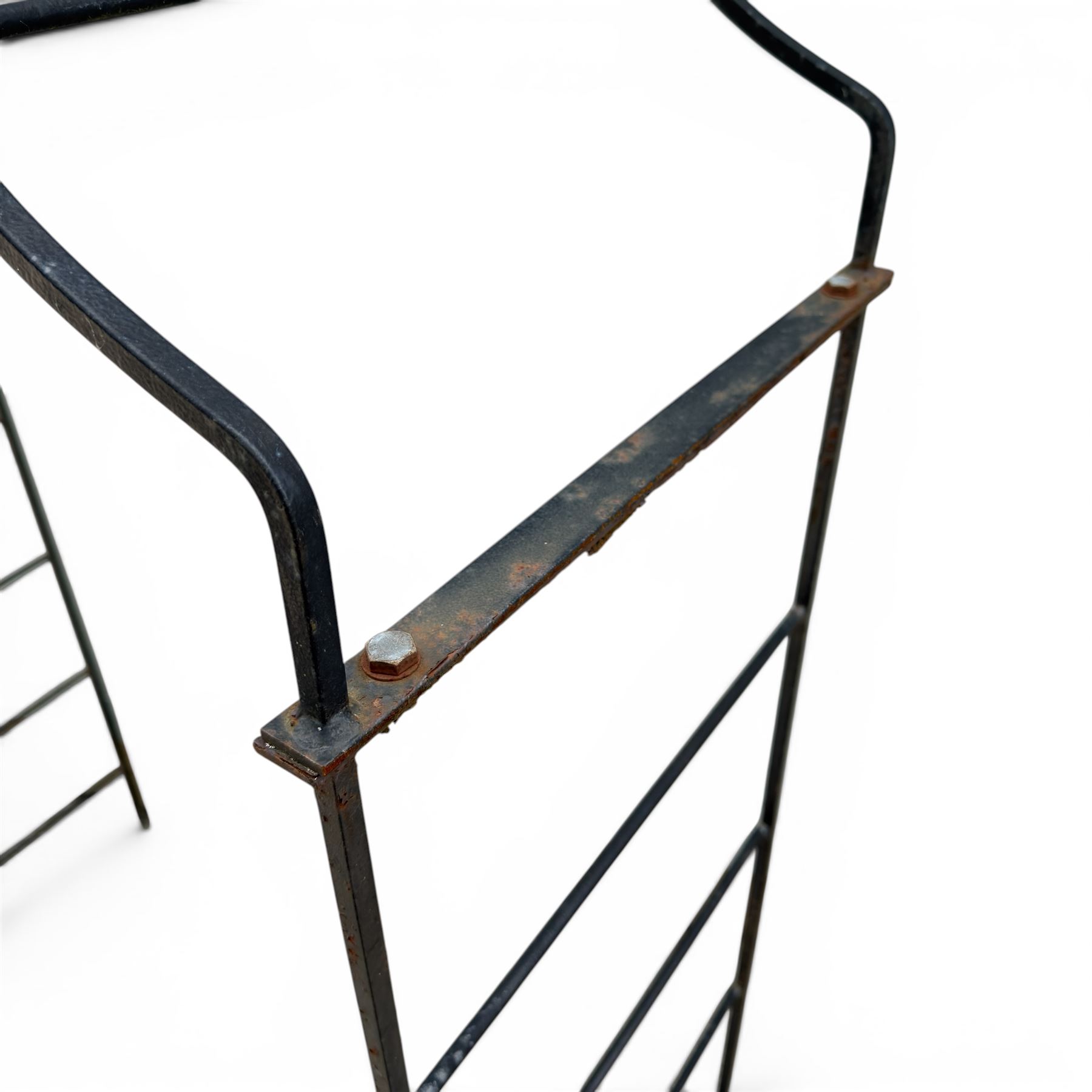 Antique wrought iron strapwork garden arch, with scroll form arched top with spearhead finials, over integral side trellis panels, in distressed black-painted finish