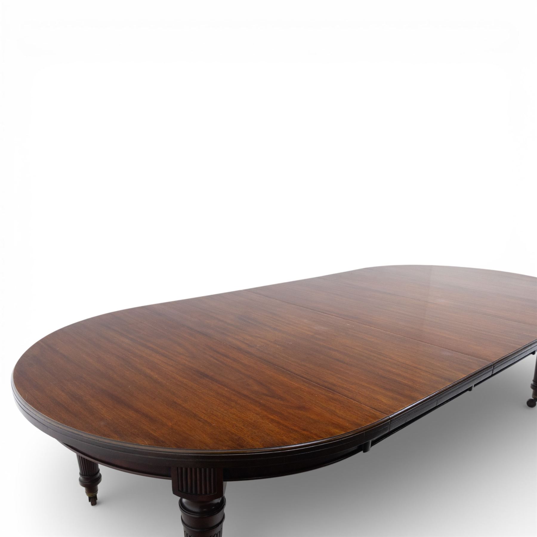 Spillman & Co. London - large Victorian mahogany extending dining table with three additional leaves, upon turned and reeded supports with ceramic castors, bearing ivorine label beneath detailed 'Spillman & Co. St. Martins Lane, London', extends to 302cm