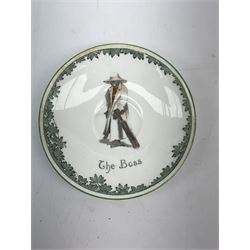 Early 20th century Royal Doulton teacup and saucer, from the series 'The All Black Team', the teacup depicting a cricketer entitled 'Good for fifty', the saucer depicting a cricketer stood in a long coat and wide brimmed hat, entitled 'The Boss', both with printed mark beneath, cup H6.5cm