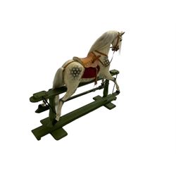 Attributed to F. H. Ayres - early 20th century carved wooden dapple grey rocking horse, with leather saddle and tack, with glass eyes, on green painted trestle base with turned column supports