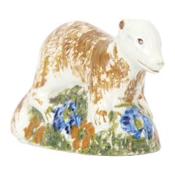 Late 18th/early 19th century Staffordshire model of a fox, the stalking fox decorated in Pratt type colours upon a green grassy mound base detailed with blue and ochre flowers, bearing Jonathan Horne labels beneath, H5.5cm L9cm

