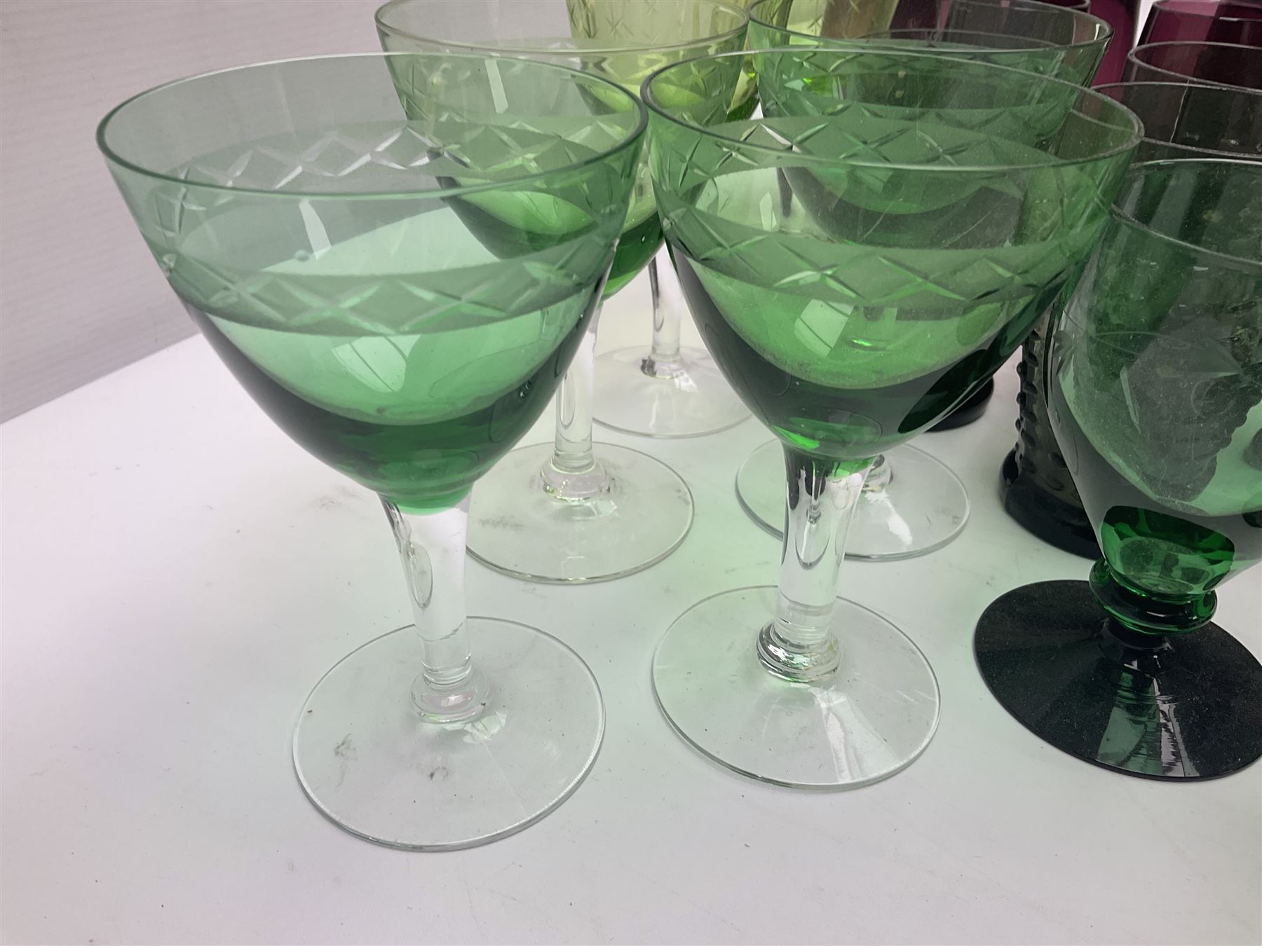 Set of four Swedish Reijmyre drinking glasses, with textured outer surface, together with green drinking glasses including Holmegaard examples and other glassware