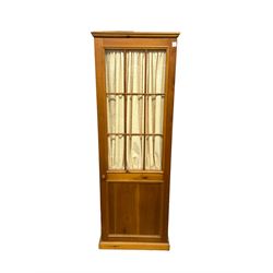 Rustic pine wardrobe, single glazed door with interior pleated curtain enclosing shelf, on castors
