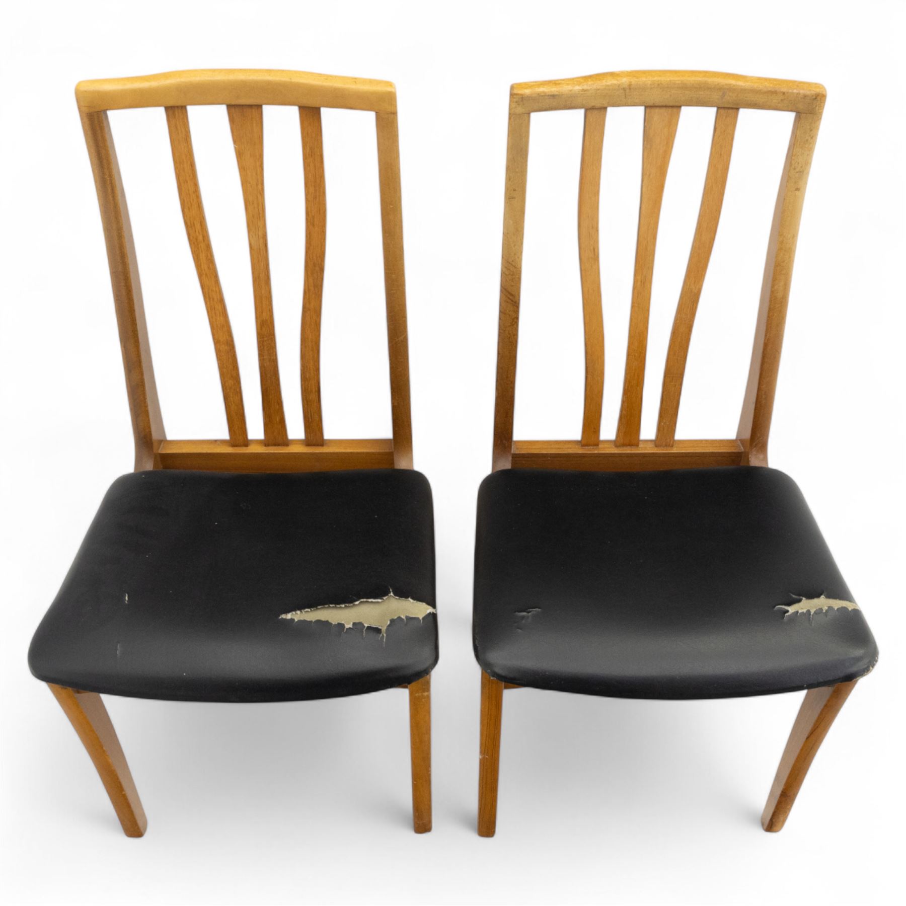 Sutcliffe of Todmorden - mid 20th century ‘S-Form’ teak dining table and chairs, the circular storable extending table with plain veneered top on tapered supports, together with matching dining chairs upholstered in black vinyl, with curved slat backs and shaped front supports, reflecting the sleek organic styling characteristic of 1960s British modern furniture design (Chairs H 93cm, W 46cm, D 46cm) (Extended 168cm)