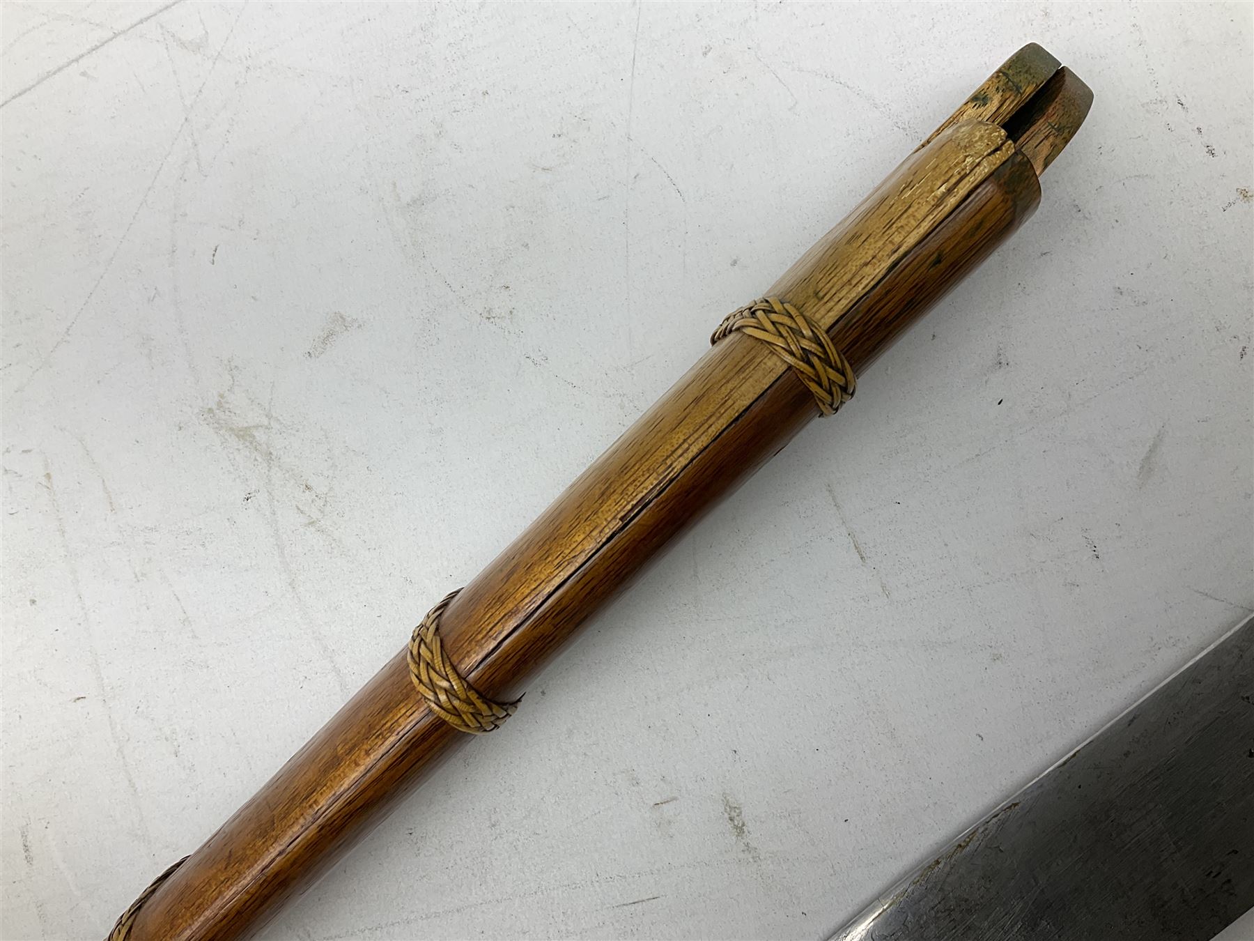 Malaysian parang survival knife the 29cm steel blade with character marks, cane bound teak grip carved with a stylised turtle head to the pommel, with matching teak scabbard L46cm overall