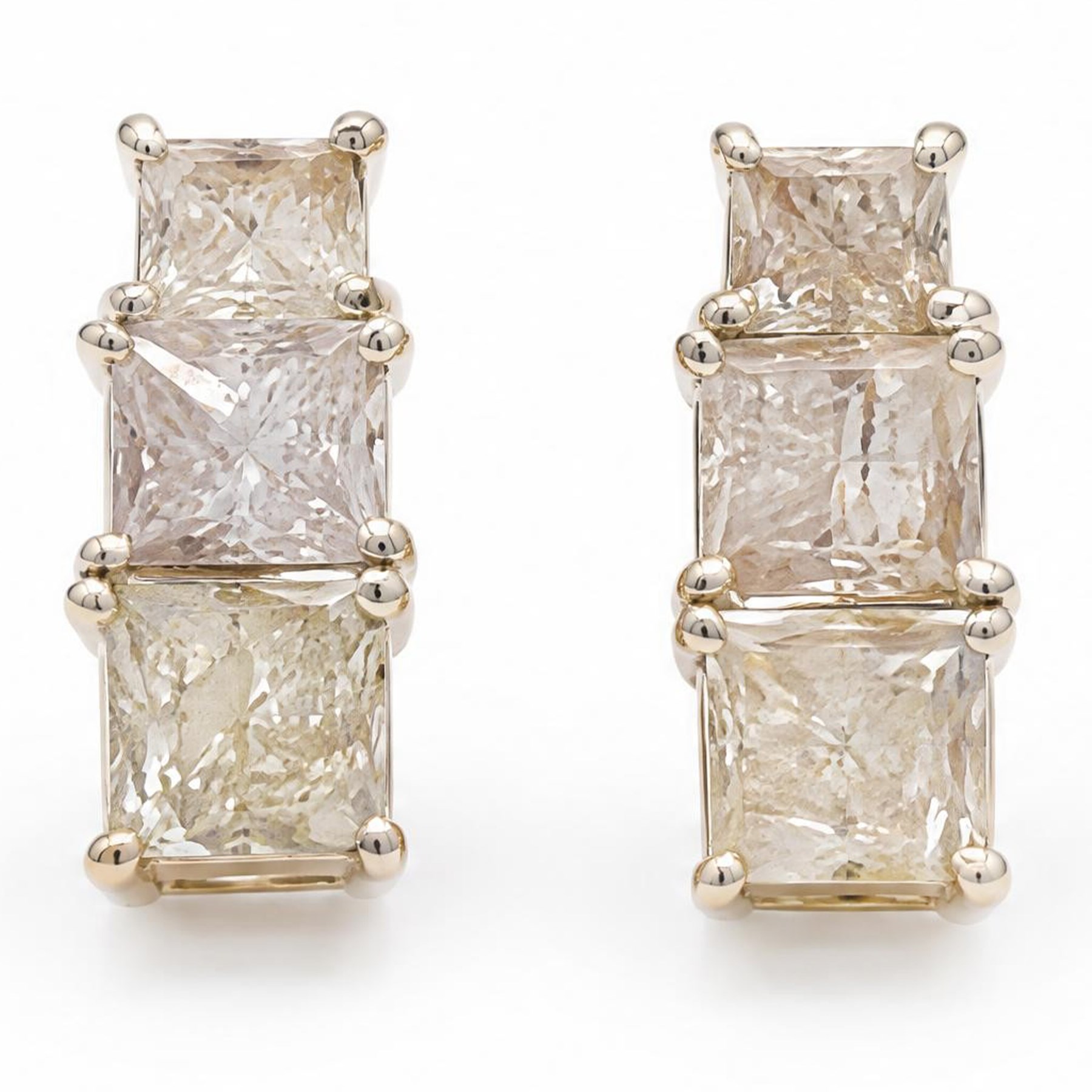 Pair of 18ct white gold diamond earrings, each stud set with three graduating princess cut diamonds, stamped 750, total diamond weight approx 1.70 carat