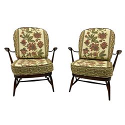Ercol - Pair of mid-20th centur medium elm framed easy chairs, with loose patterned covers with folate design