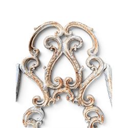 Pair of Victorian cast iron garden chairs, the ornate pierced back of scrolling foliate design, scrolling arm terminals over splayed supports formed of C and S-scrolls, in distressed white painted finish