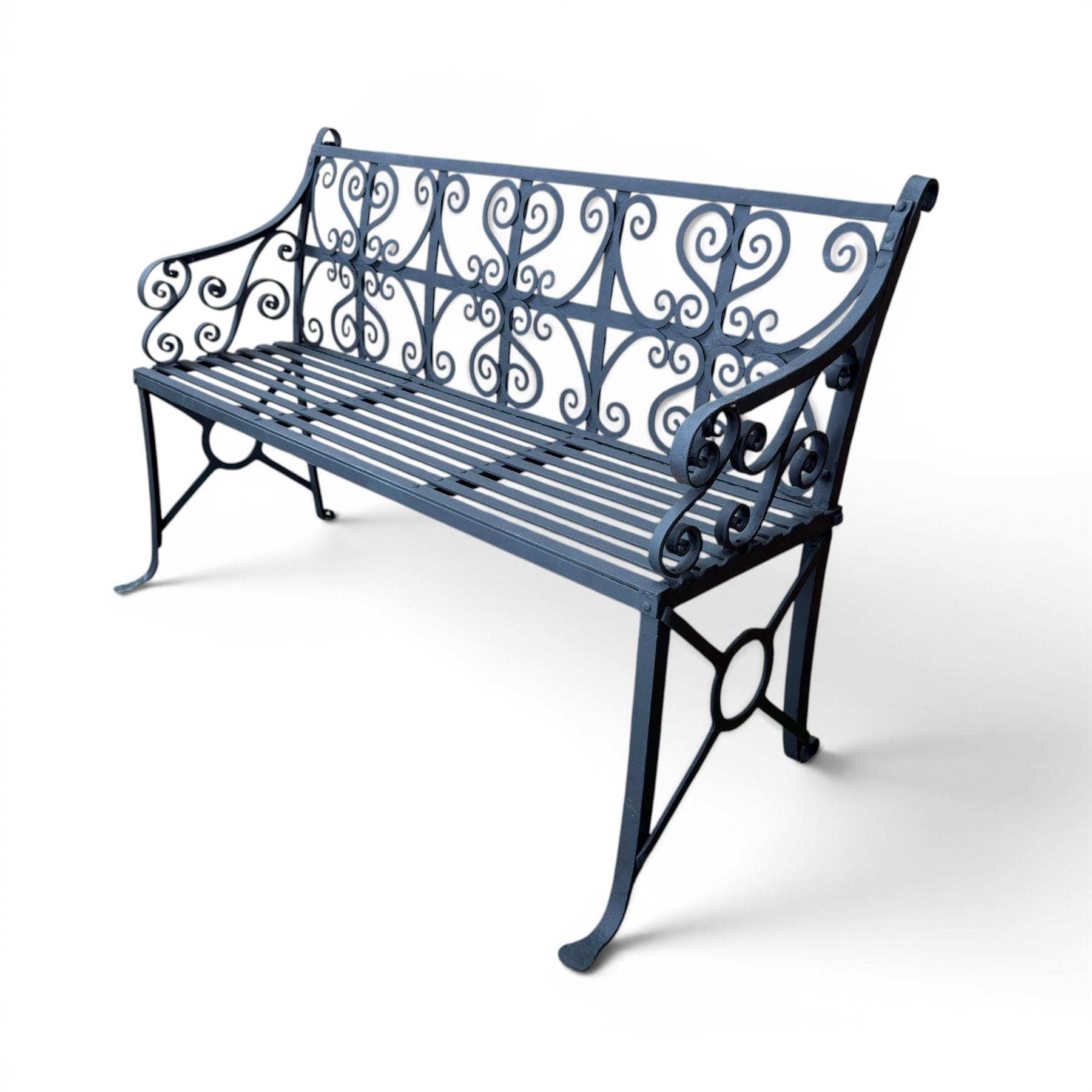 Regency period wrought iron garden bench, hand forged in wrought iron and finished in matt black paint, decorated with intricate scrollwork and featuring circular geometric ends, strapwork seat