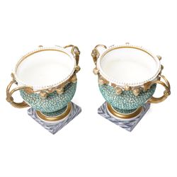 Pair of 19th century Grainger Lee & Co Worcester urns, c1820s-1830s, hand-painted with views of 'Near London Bridge' and 'Brighton Pavilion' upon a ground of encrusted forget-me-not decoration, the beaded rim with twin naturalistically formed handles, leading into vines moulded with strawberries in high relief, the pedestal painted to imitate marble, painted marks to base, H20cm