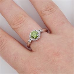 18ct white gold diamond cluster ring, the principal round brilliant cut fancy green diamond of approx 0.65 carat, surrounded by round brilliant cut white diamonds and diamond set shoulders, Birmingham 2007, total white diamond approx 0.20 carat