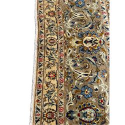 Persian Meshed carpet, ivory ground and decorated with intricate floral design with trailing scrolled branch, the central medallion decorated with stylised plant motifs, seven band border, the main band decorated with scrolls and flower head motifs