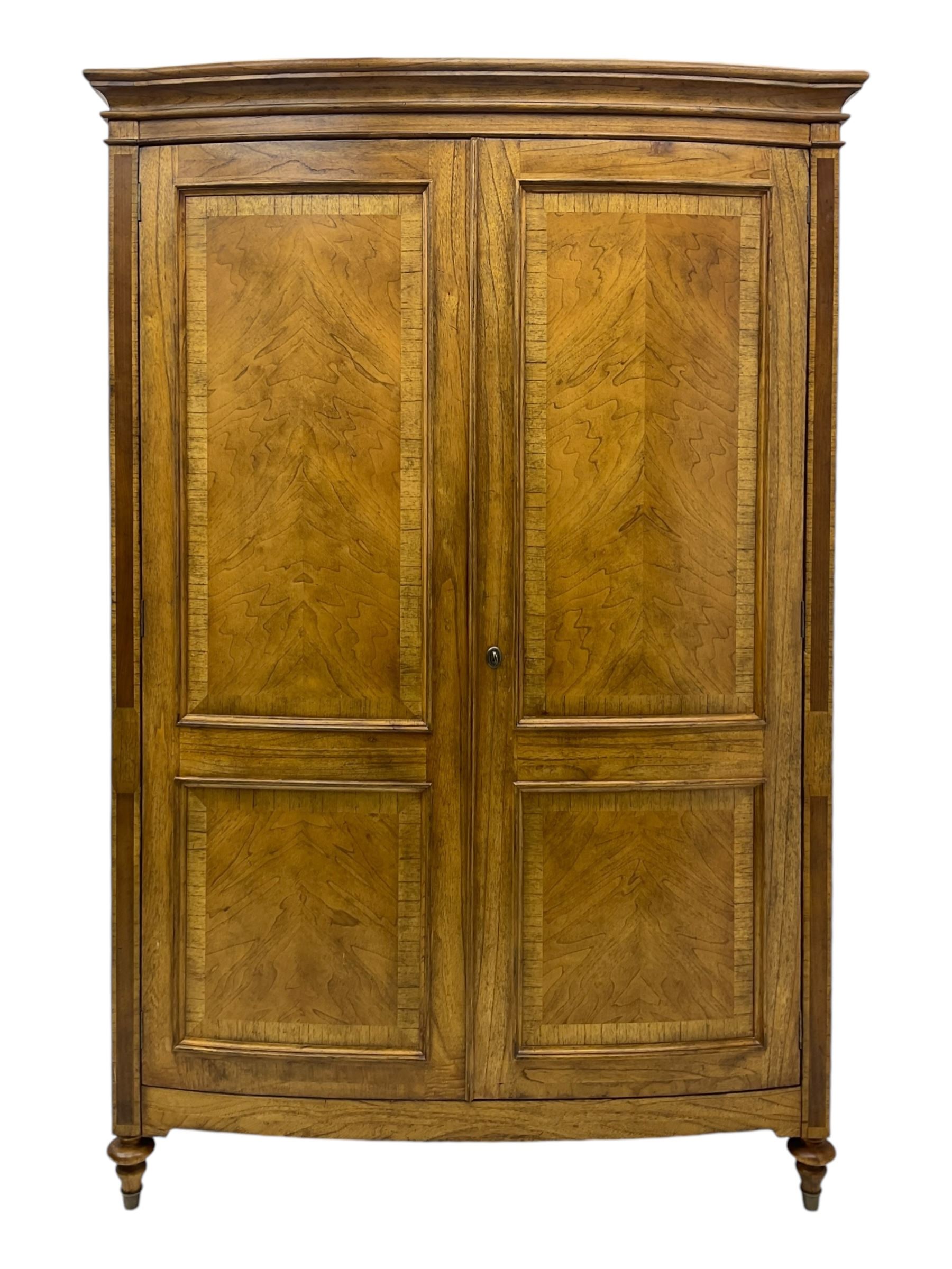 Frank Hudson - mid-20th century Mindi ash and burr walnut double wardrobe, moulded rectangular cornice over two panelled doors with chevron pattern veneers, raised on turned supports