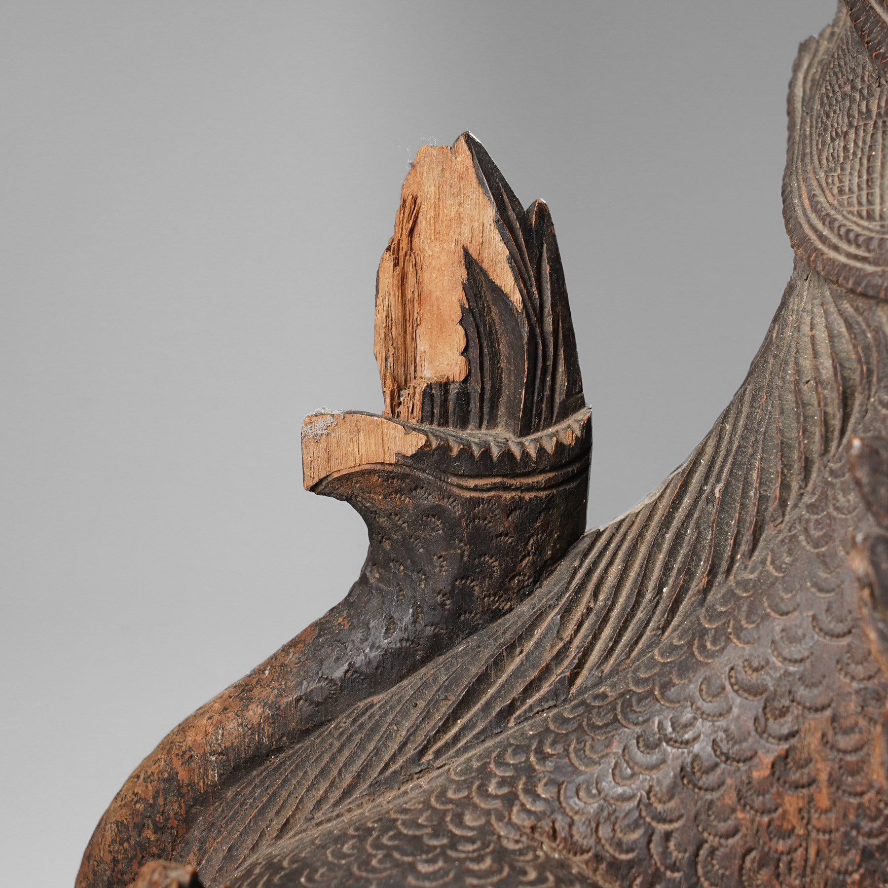 Burmese carved temple guardian figure, depicted seated with carved flame details, H52cm 