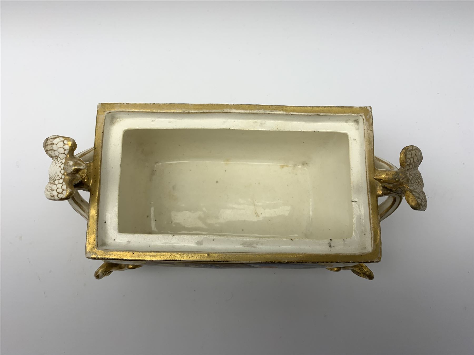 19th century Coalport bough pot, circa 1820, of bombe form, the body with twin handles surmounted by two birds and raised upon four feet modelled as swans, hand painted with two panels depicting an urn of flowers set against a mountainous landscape, the whole heightened in gilt throughout, H13cm L21cm