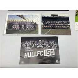 Hull F.C. memorabilia; Clive Sullivan 1986 memorial game programme, Open Evening 1994 programme with multiple player signatures, 'Old Faithful' 45rpm record, Wembley rosettes, 2000 team poster with facsimile signatures, framed print 'Farewell to the Boulevard 1895-2002', fully signed team photograph, various booklets, CD, DVD etc; and a folder containing the Merlin Rugby League card collection