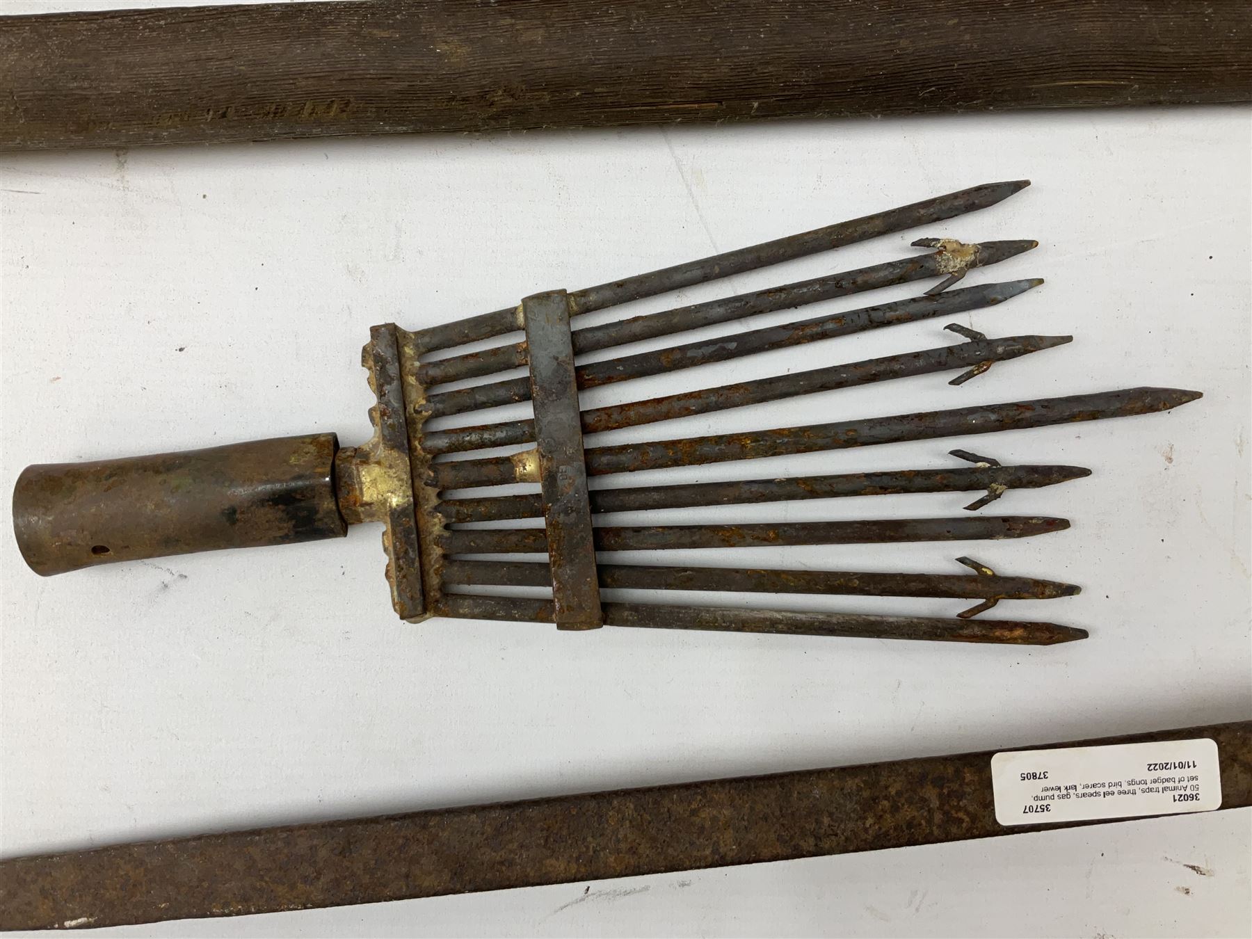 Blue and red painted gas powered bird / pest scarer, bearing label 'Exid bird & pest scarer, imported by C.R.E.A.C.O Hadleigh, Essex', , copper and brass Cymag gas hand pump, three eel spears and a set of badger tongs. Auctioneer's Note: These traps are sold as artefacts for ornamental purposes only as the use of some of them is illegal.