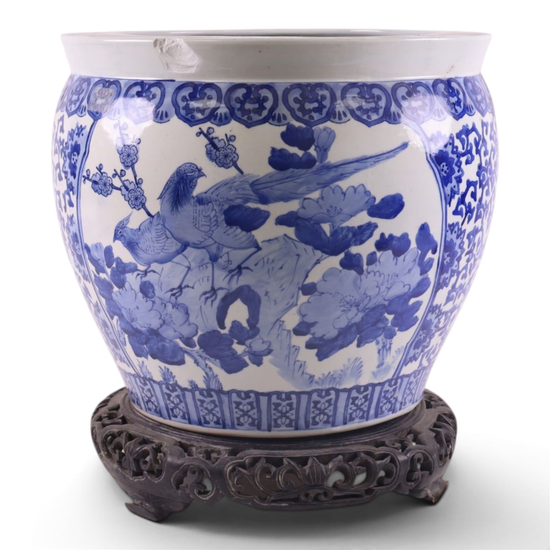 20th century blue and white fishbowl planter, decorated with birds in blossoming branches, internally decorated with goldfish, upon a wooden base, H44cm