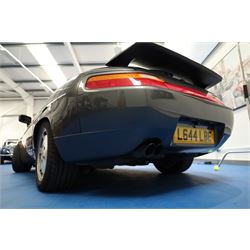 1991 Porsche 928 S4 Automatic Coupé

Registration: L644 LBE
Date of first registration as shown on V5: 1 July 1994
Porsche year of manufacture: 1991
Engine: 5.0-litre V8 petrol
Transmission: Automatic
Odometer reading: 37,886 kilometres (approximately 23,541 miles)
Colour: Slate Grey metallic
Interior: Black leather
V5C: Present
Keys: One
Chassis number: WP0ZZZ92ZMS800460

An exceptional Porsche 928 S4 Automatic Coupé finished in Slate Grey metallic with a black leather interior. The car displays a notably low odometer reading of just 37,886 kilometres, equivalent to approximately 23,541 miles.

The 928 S4 combined Porsche’s powerful 5.0-litre V8 engine with a sophisticated rear-mounted transaxle, creating a refined and accomplished grand tourer. This example is equipped with automatic transmission, electrically adjustable front seats, air conditioning, alloy wheels and the characteristic rear spoiler.

The car was purchased from Specialist Cars of Malton in June 2019, at which time the recorded mileage was 36,650 kilometres. The accompanying service record includes evidence of a cam belt replacement.

Presented in excellent condition throughout, the bodywork and metallic paint finish appear particularly well preserved, while the cabin retains its original character with black leather upholstery and 928-branded sill trims. A Japanese Porsche service label records maintenance entries at 31,902, 33,397 and 34,134 kilometres.

The car also features a Porsche Classic Communications Management (PCCM) upgrade system.

Features

• 5.0-litre V8 petrol engine
• Automatic transmission
• Slate Grey metallic paintwork
• Black leather interior
• Electrically adjustable front seats
• Air conditioning
• Porsche alloy wheels
• Rear spoiler
• Right-hand drive
• Odometer reading of 37,886 kilometres, approximately 23,541 miles
• Purchased from Specialist Cars of Malton in June 2019
• Recorded at 36,650 kilometres when purchased
• Service record showing cam belt replacement
• Japanese Porsche service label
• V5C present
• One key

This vehicle forms part of the Estate of the Late John Sils and is offered for sale by the Executors, confirming a genuine reason for sale.
