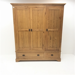 Light oak triple wardrobe, projecting cornice, three doors enclosing hanging rail and shelves above two drawers,  shaped bracket supports, W165cm, H196cm, D59cm