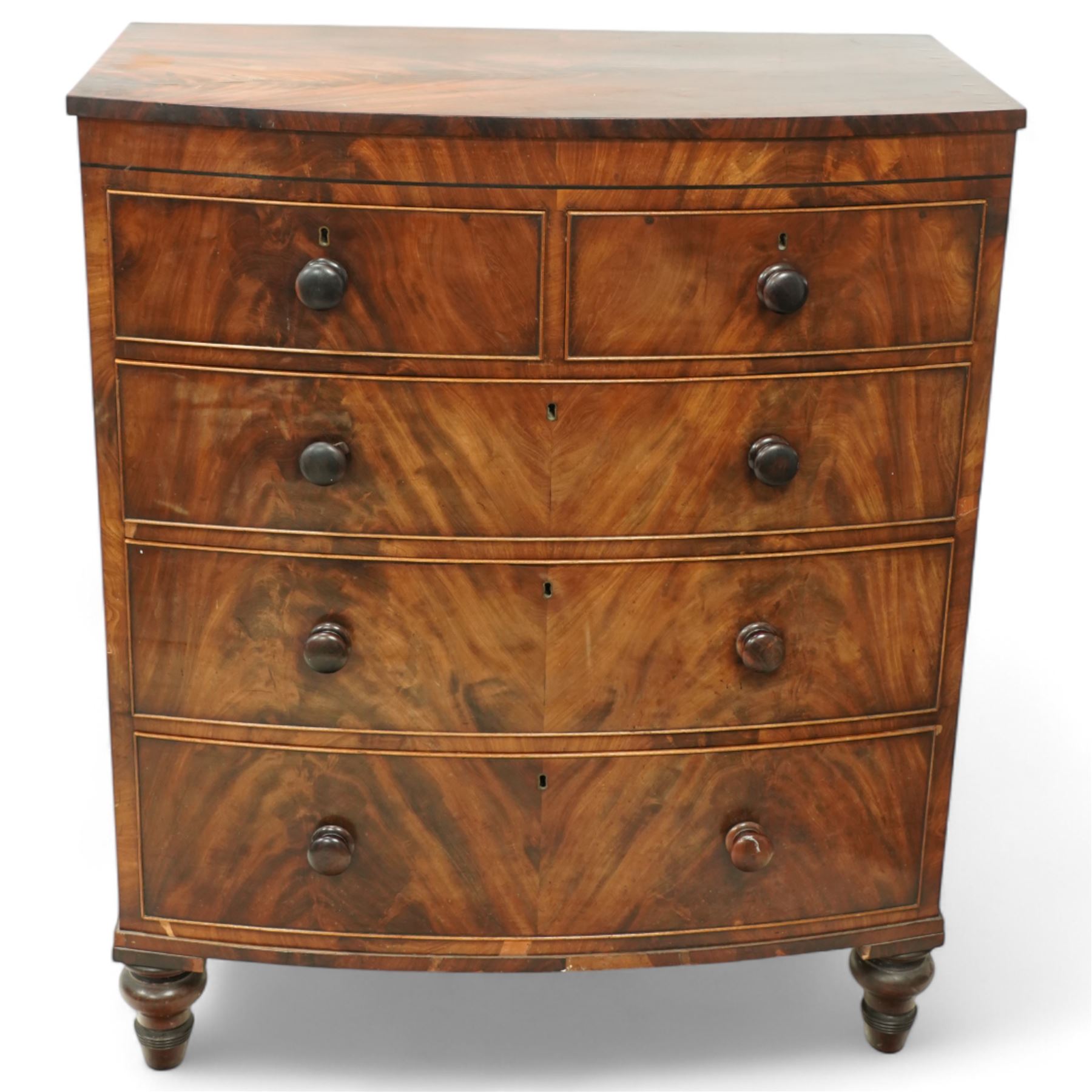 19th century mahogany chest of drawers, bow fronted form with two short over three long drawers, each veneered in matched flame mahogany, on turned feet