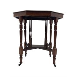 Victorian oak occasional table, octagonal top with bevelled edges, lower section fitted with a square undertier united by decorative shaped stretchers, on turned supports with castors