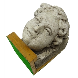  Carved stone corbel carved with a female head, mounted on oak stand, D29cm, W17cm x H22cm   