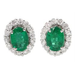 Pair of 18ct white gold oval emerald and round brilliant cut diamond cluster stud earrings, stamped 18K, total emerald weight approx 1.55 carat, total diamond weight approx 0.70 carat