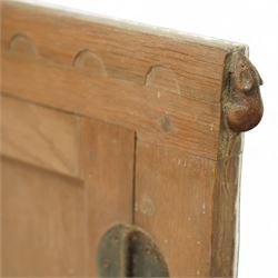 Mouseman - oak cupboard fascia or hatch, of rectangular form with twin panelled doors, circular hinges, raised on plinth, with carved mouse signature, by the workshop of Robert Thompson, Kilburn