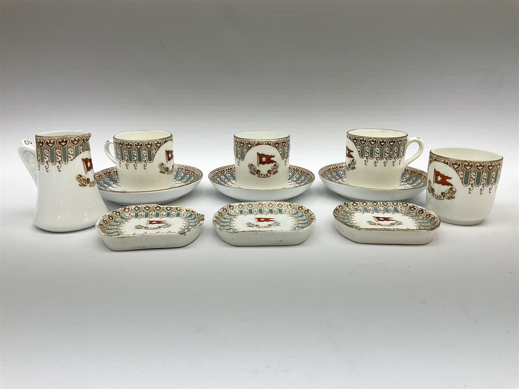 White Star Line, six pieces of porcelain by Stonier & Co. Liverpool, comprising four tea cups, three saucers, jug and three pin trays, registered design no. 117214/324028, printed mark beneath 