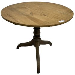 Early 19th century pine and elm tripod table; circular tilt-top over turned column and three splayed supports