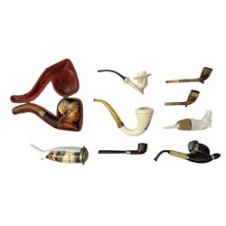 Carved meerschaum and amber pipe with silver mount, the bowl carved as a woman, cased, clay pipe in the form of an acorn, ceramic pipe, five other pipes and a ceramic bottle pourer in the form of a horse  