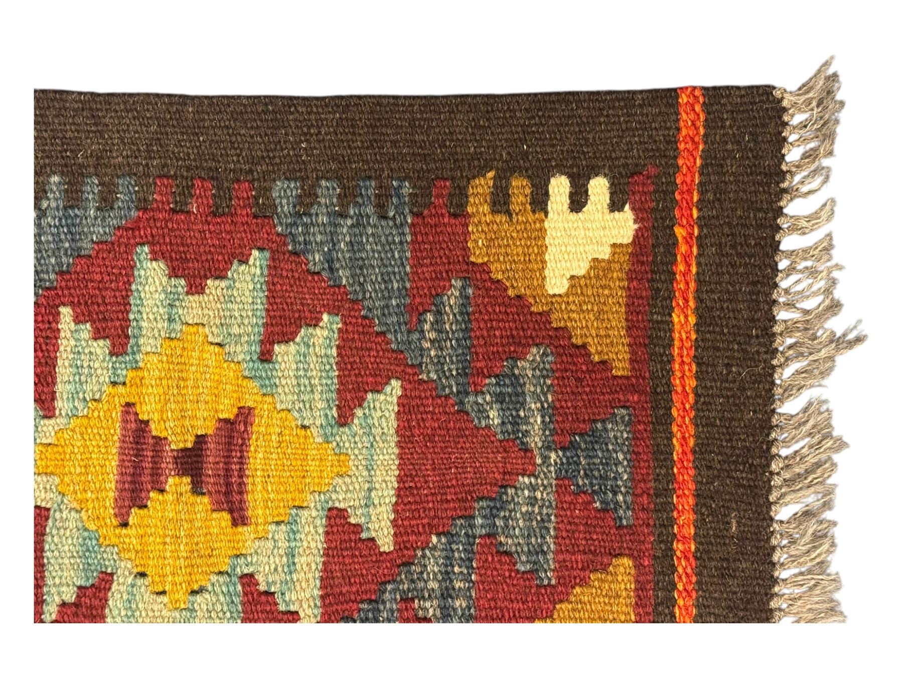 Maimana Kilim ground runner, multicoloured geometric medallions arranged in rows, with triangular motifs in the field, the wide border in brown with contrasting guard bands