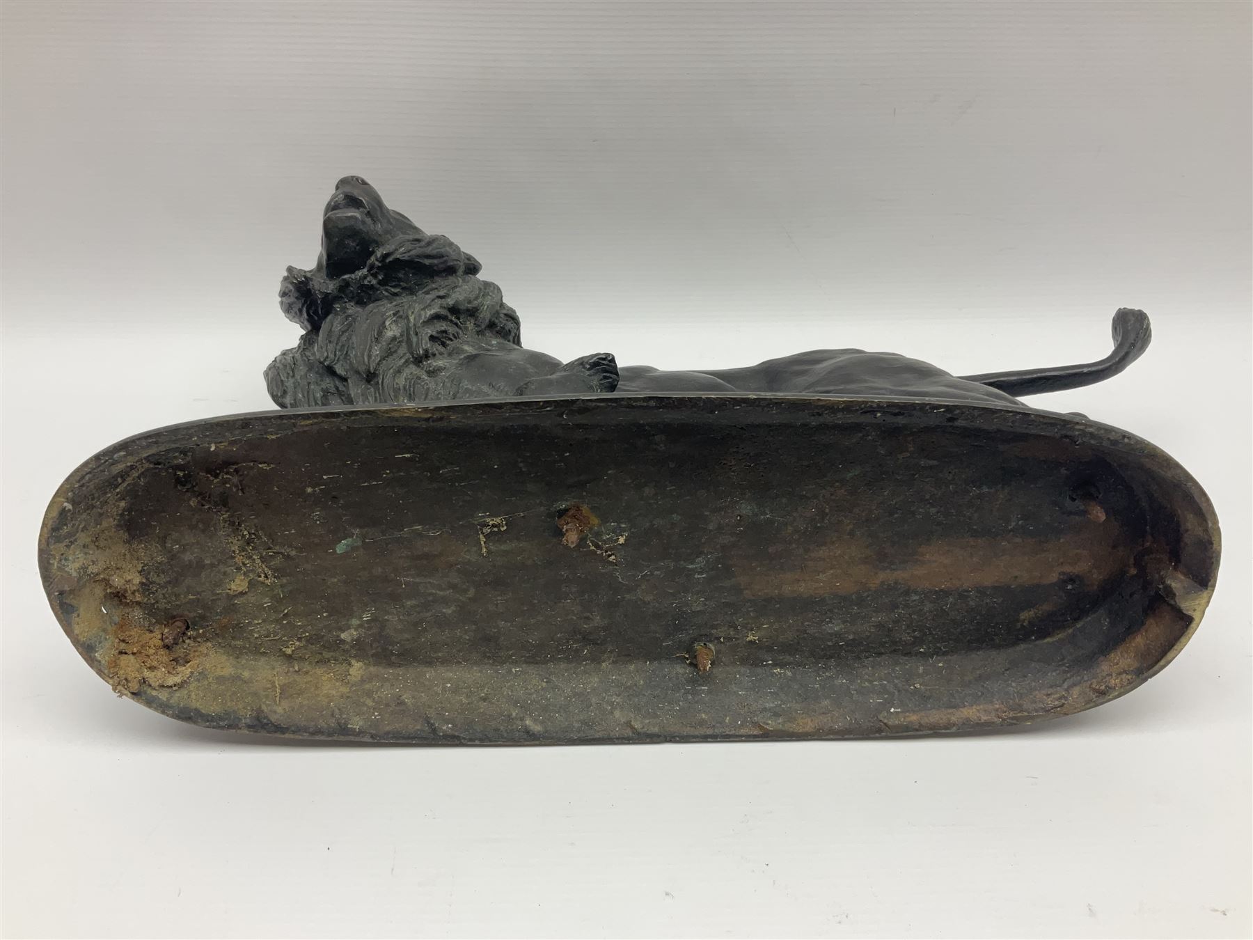 After Paul Edouard Delabrierre (French, 1829-1912), bronze, model of a lion, upon an oval base, signed E Delabrierre, overall H29.5cm, L46cm