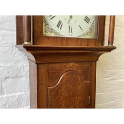 Thirty-hour oak cased longcase clock by  William Bancroft of Scarborough circa 1830, with a swan’s neck pediment, brass patera and three brass spire and ball finials, stepped break arch hood door flanked by plain pillars with brass capitals, trunk with a full length door and curved arch top, on a plain square plinth with bracket feet, painted break arch dial with roman numerals and quarter hour Arabic’s, date recorder (anti clockwise) and matching brass hands, arch painted with a rural scene depicting a ruined tower and cottage with depictions of flowers to the spandrels, dial pinned directly to a chain driven countwheel striking movement, striking the hours on a bell. With weight and pendulum. The Bancroft family were prodigious Scarborough clockmakers during the 18th and 19th century, William Bancroft is recorded as working in Newborough Street from 1820 onwards. 


