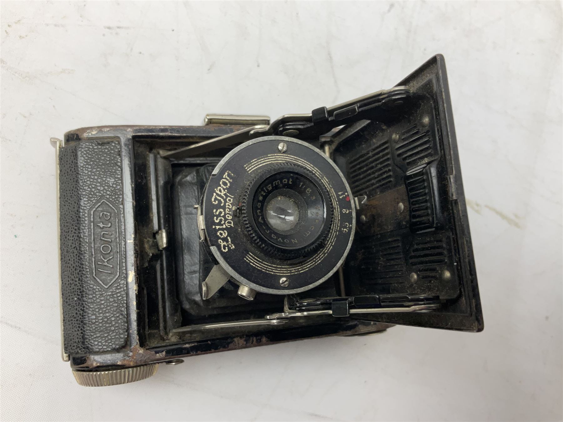 Bilora Boy Box Camera, with leather case, together with Zeiss Ikonta folding camera and another similar example 