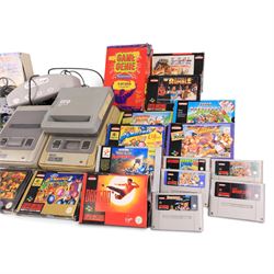 Two Super Nintendo Entertainment System consoles, accessories to include Super Multitap, UFO Super Drive Pro, Universal Adapter, Game Genie, Scope 6 accessories (Scope not present), seven controllers including one Competition Pro and a SN Pro Pad and fifteen SNES games comprising eleven boxed and four unboxed examples, titles to include Dragon The Bruce Lee Story, Street Fighter II Turbo x2 (one unboxed), Royal Rumble, Super Mario Kart, Radical Psycho Machine Racing, Super Bomberman, Super Bomberman 2, Protector Alien Rebels, Double Dragon, Goof Troop, WWE Raw Wrestling, Tetris Attack, Donkey Kong Country and Starwing