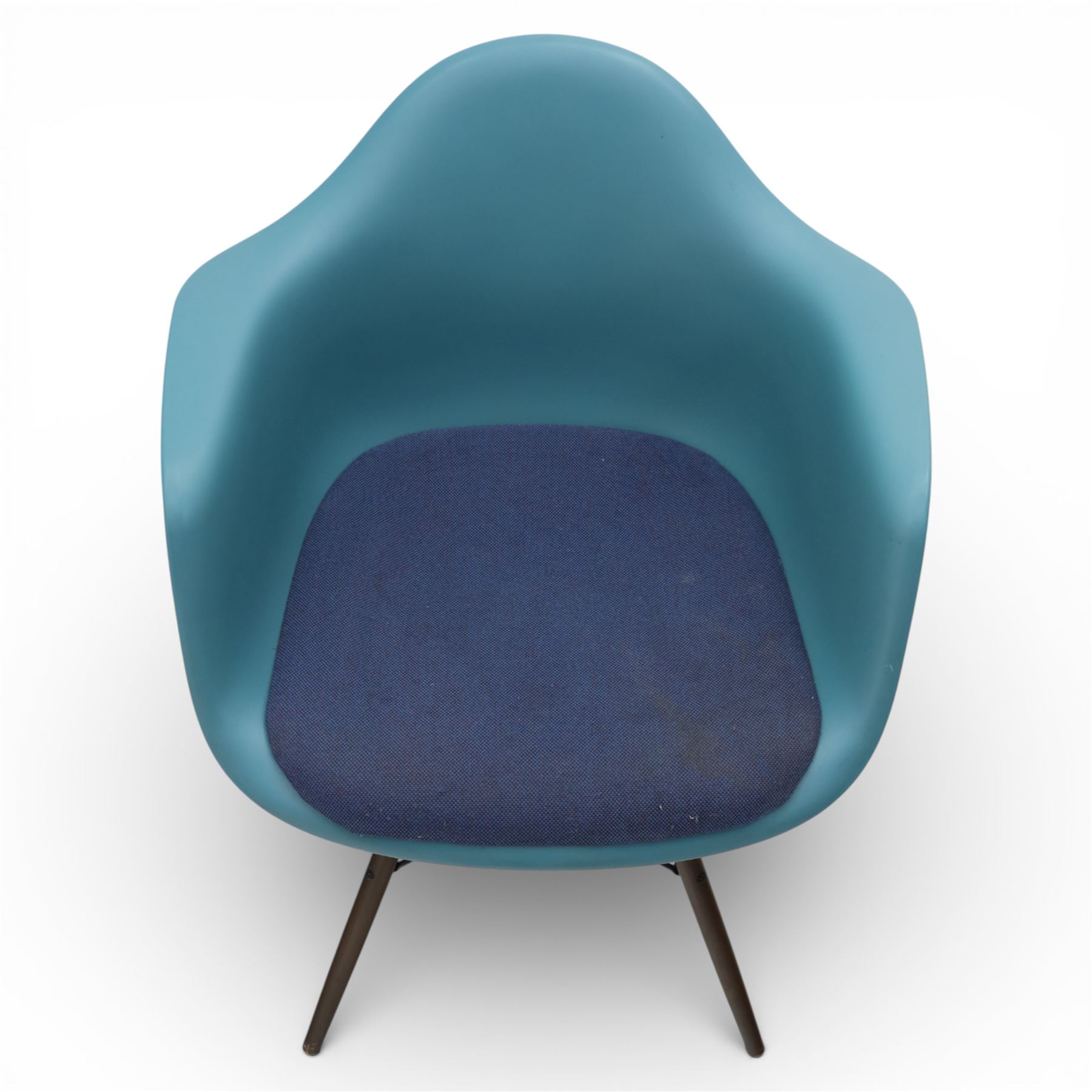 Vitra - Pair of Eames DAW armchairs, moulded plastic seats in teal with integrated armrests, blue upholstered seat cushions, supported on stained wooden dowel legs with black wire cross bracing